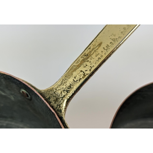 241 - BATTERIE DE CUISINE, a graduated set of twelve, copper pans, with brass handles. (12)