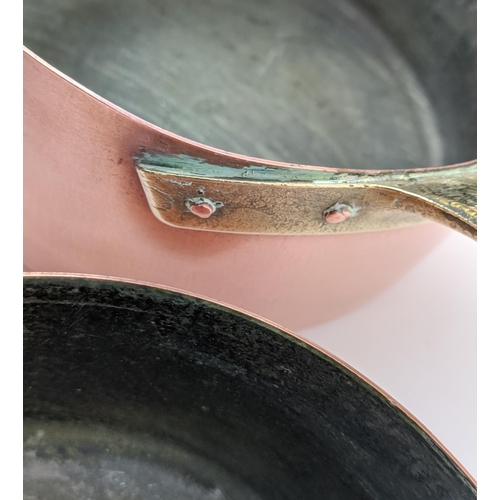 241 - BATTERIE DE CUISINE, a graduated set of twelve, copper pans, with brass handles. (12)