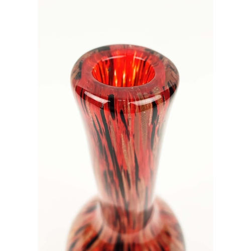 10 - A MURANO STYLE GLASS VASE, of bottle form, red ground with black and gold coloured streaks, 31cm hig... 