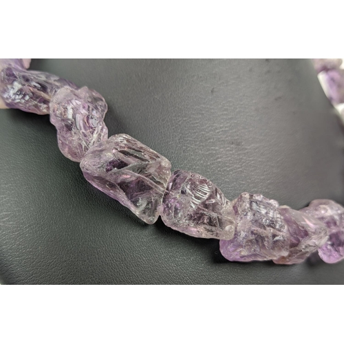 16 - ELENA VOTSI NECKLACES, comprising one in amethyst and the other in rose quartz, each with a silver c... 