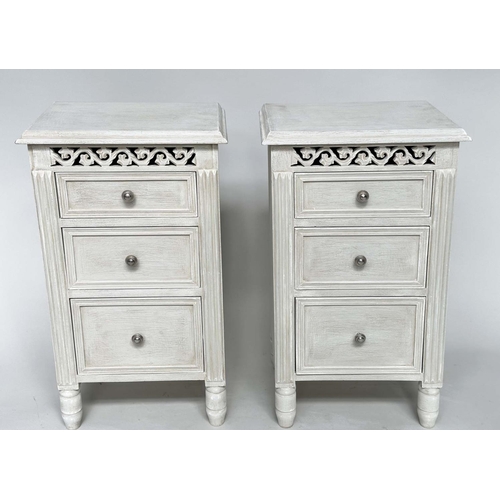 204 - BEDSIDE CHESTS, a pair, French style grey painted each with three drawers and pierced frieze, 40cm x... 