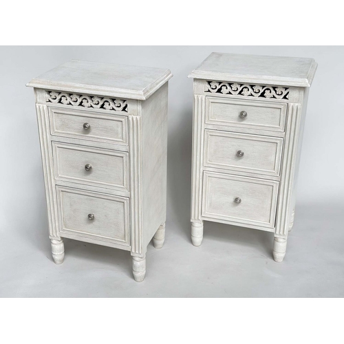 204 - BEDSIDE CHESTS, a pair, French style grey painted each with three drawers and pierced frieze, 40cm x... 