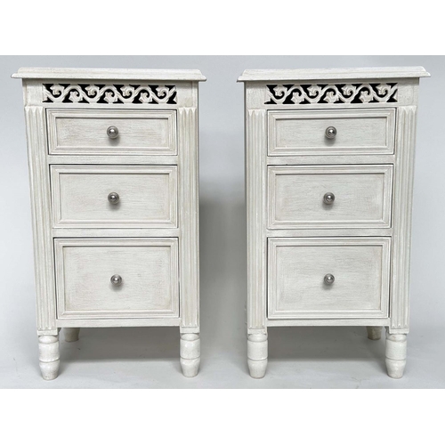 204 - BEDSIDE CHESTS, a pair, French style grey painted each with three drawers and pierced frieze, 40cm x... 