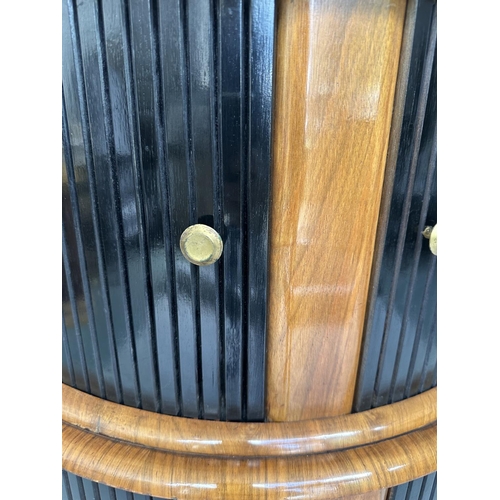 194 - COCKTAIL CABINET, 1960's demi lune walnut with double tambour sliding doors, shelved and glazed inte... 
