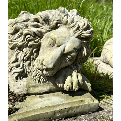 217 - GARDEN LIONS, a pair, well weathered reconstituted stone recumbent, 21cm H x 42cm W x 22cm D. (2)