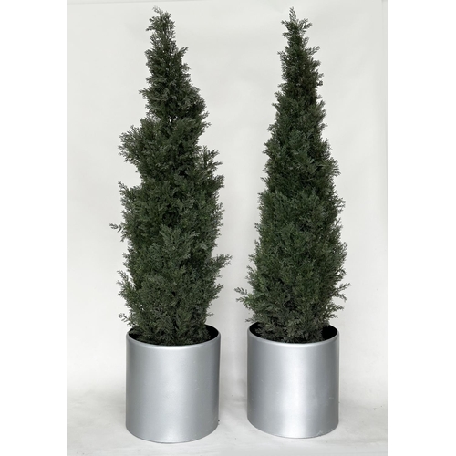 216 - ARTIFICIAL CONIFERS, a pair, in silvered metal drum planters, planters 49cm W, heights overall appro... 