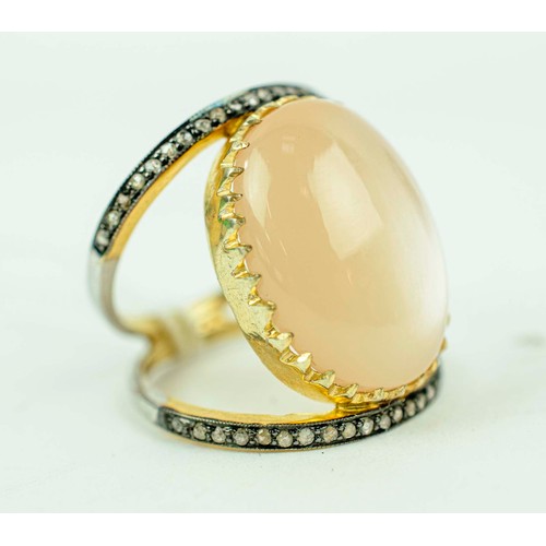 43 - A CABOUCHON AND DIAMOND DRESS RING, set with a moonstone coloured cabouchon of approximately 14.70 c... 