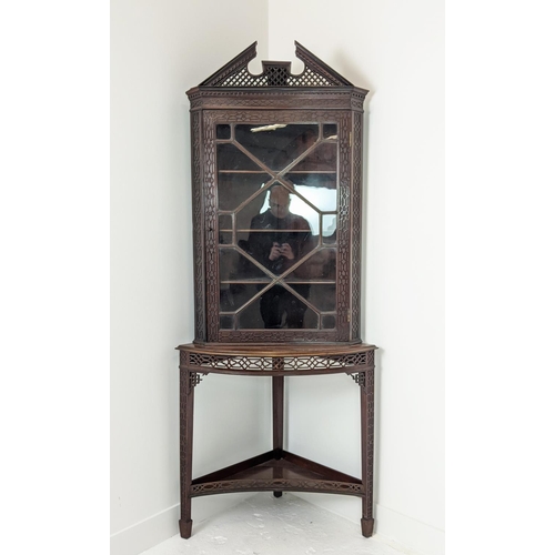 168 - GLAZED CORNER CABINET ON STAND, Edwardian mahogany in Chippendale style with door and carved fretwor... 