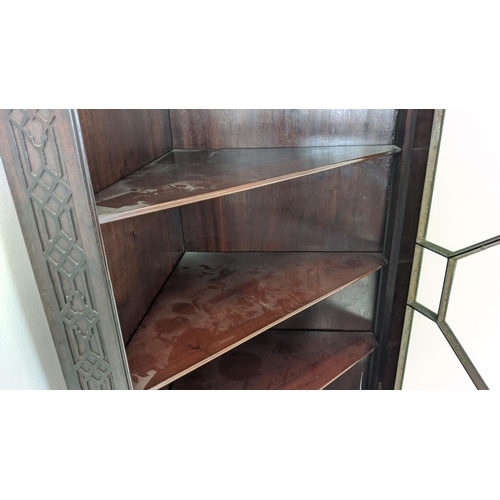 168 - GLAZED CORNER CABINET ON STAND, Edwardian mahogany in Chippendale style with door and carved fretwor... 