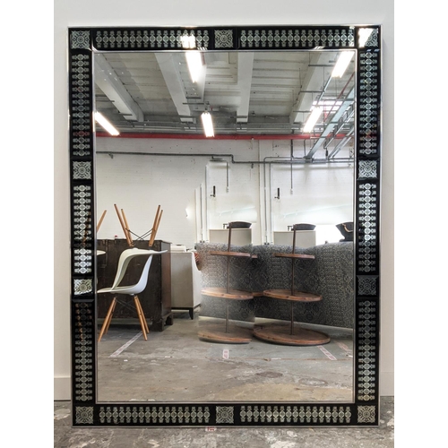 281 - WALL MIRROR, chrome framed with black decorated border, 176cm H x 133cm W.