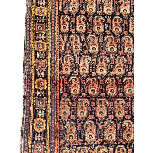 99 - ANTIQUE PERSIAN PAISLEY DESIGN RUG, 210cm x 137cm.