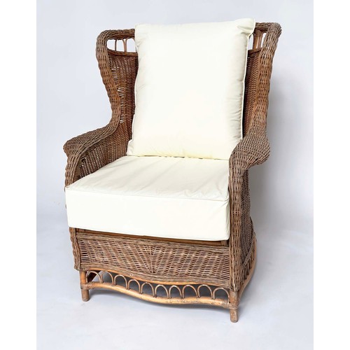 134 - CONSERVATORY ARMCHAIR, mid 20th century rattan framed and cane woven with shaped back and cushions, ... 