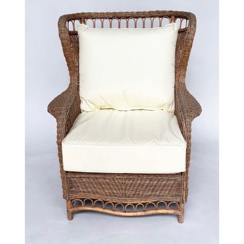 134 - CONSERVATORY ARMCHAIR, mid 20th century rattan framed and cane woven with shaped back and cushions, ... 