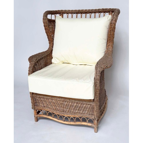 134 - CONSERVATORY ARMCHAIR, mid 20th century rattan framed and cane woven with shaped back and cushions, ... 