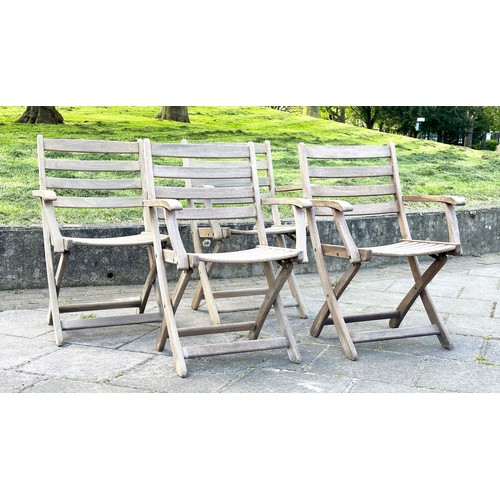 137 - GARDEN ARMCHAIRS BY ALEXANDER ROSE, a set of four, nicely weathered teak each folding with arms, Sus... 