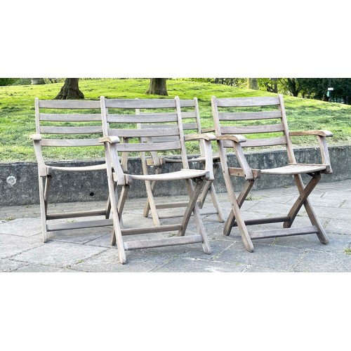 137 - GARDEN ARMCHAIRS BY ALEXANDER ROSE, a set of four, nicely weathered teak each folding with arms, Sus... 