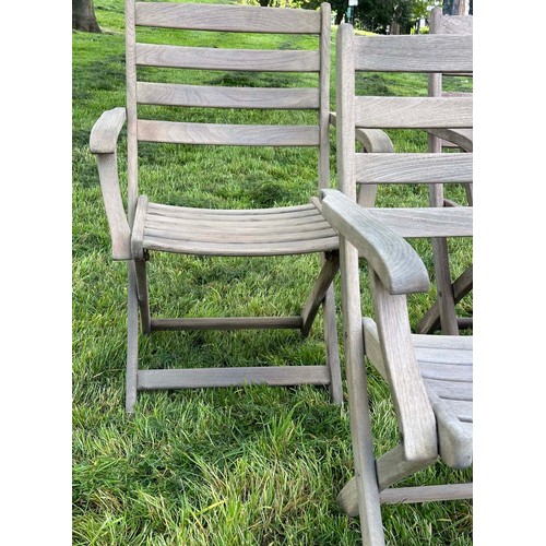 137 - GARDEN ARMCHAIRS BY ALEXANDER ROSE, a set of four, nicely weathered teak each folding with arms, Sus... 