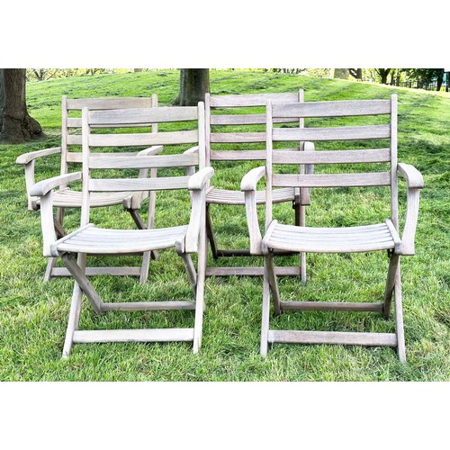 137 - GARDEN ARMCHAIRS BY ALEXANDER ROSE, a set of four, nicely weathered teak each folding with arms, Sus... 