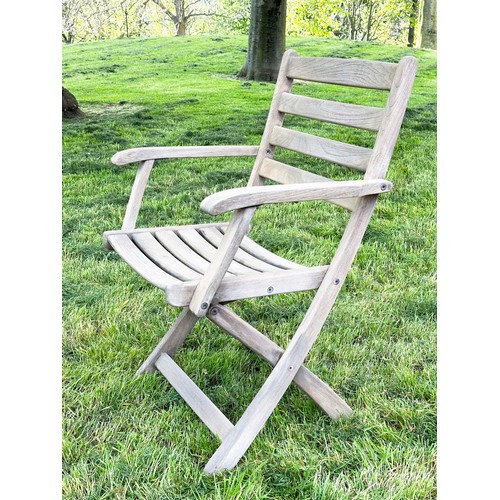 137 - GARDEN ARMCHAIRS BY ALEXANDER ROSE, a set of four, nicely weathered teak each folding with arms, Sus... 