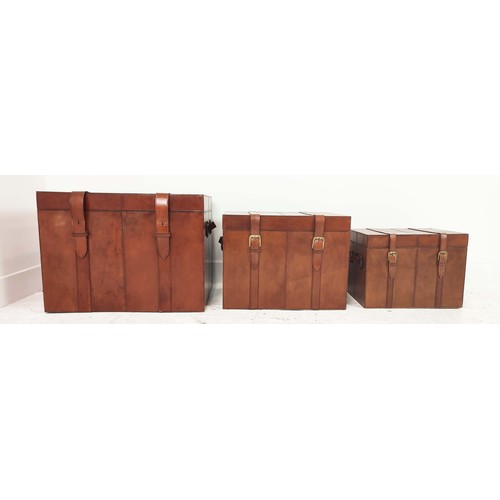 408 - TRUNKS, a graduated set of three, each with buckle closing lids, 61cm x 46cm x 46cm at largest. (3)