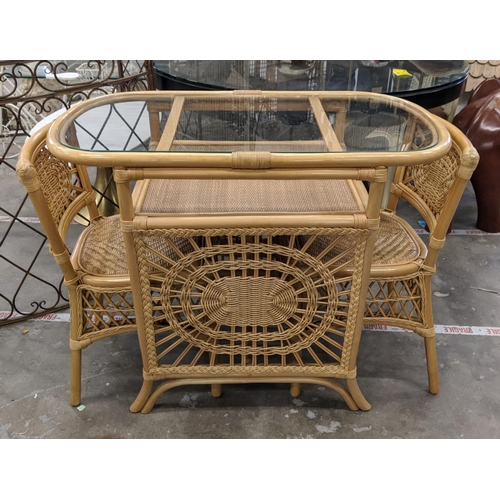 448 - TERRACE SET, wicker table with glass top, 80cm H x 100cm x 55cm and a pair of matching chairs. (3)