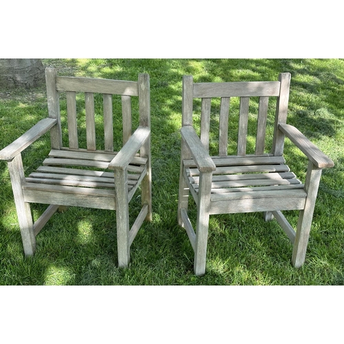 132 - GARDEN ARMCHAIRS, a pair, silvery weathered teak and slatted with flat top arms, 86cm H x 50cm W x 5... 