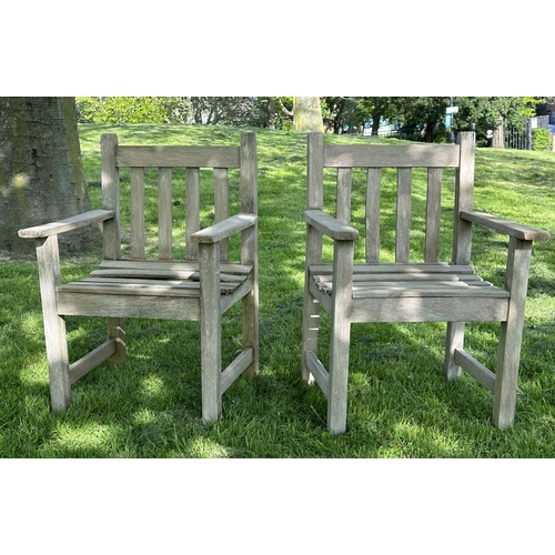 132 - GARDEN ARMCHAIRS, a pair, silvery weathered teak and slatted with flat top arms, 86cm H x 50cm W x 5... 