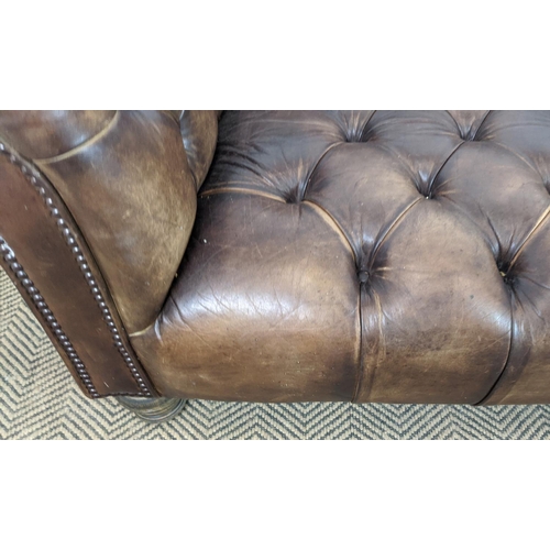 583 - SOFA, deep seated in buttoned brown leather, 74cm H x 205cm W x 107cm D.