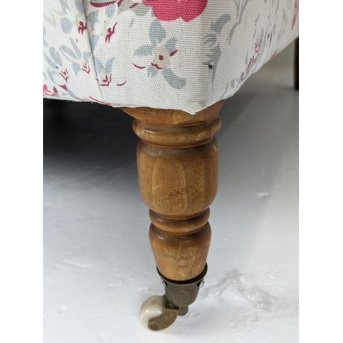 199 - SOFA, three seater, upholstered in Cath Kidson fabric with turned front supports and castors, 215cm ... 