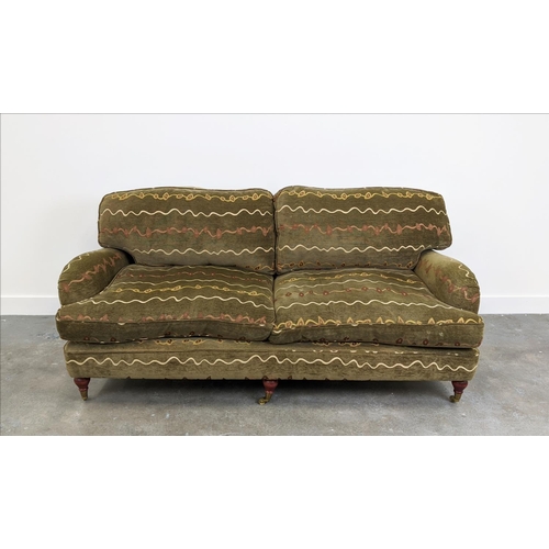 205 - HOWARD STYLE SOFA, two seater with geometric upholstery and turned front supports with brass castors... 