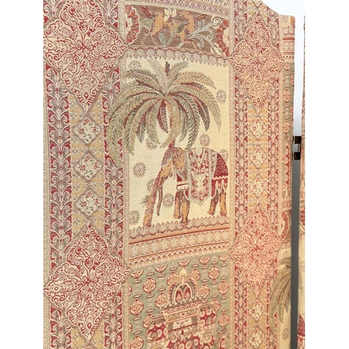 223 - SCREEN, three fold arched 'Raj' fabric, upholstered with elephants and palm trees and brass studded,... 