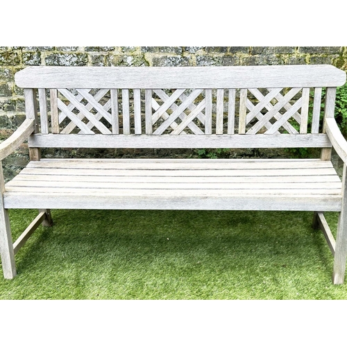 271 - GARDEN BENCH, well weathered silvery teak of slatted construction with lattice panelled back, 160cm ... 