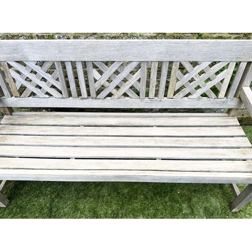 271 - GARDEN BENCH, well weathered silvery teak of slatted construction with lattice panelled back, 160cm ... 