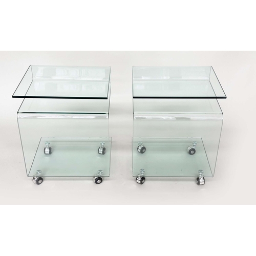 387 - CALLIGARIS OCCASIONAL TABLES, a pair, glass shaped each with shelf, under tier and castors, 42cm x 3... 