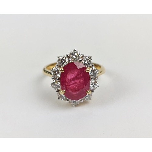 42 - AN 18CT GOLD RUBY AND DIAMOND CLUSTER RING, the mixed cut ruby of 4.11 carats, surrounded by ten rou... 