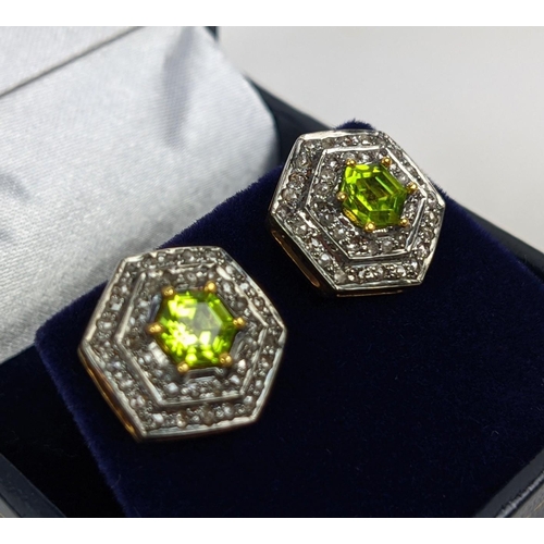 46 - A PAIR OF STUD EARRINGS, silver gilt, hexagonal form, each set with a single peridot, surrounded by ... 