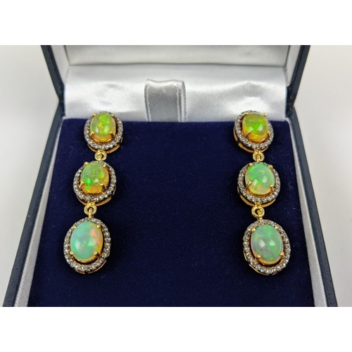 48 - A PAIR OF SILVER-GILT OPAL AND DIAMOND SET PENDANT EARRINGS, of triple sectioned droplet form, each ... 