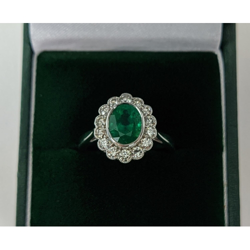 49 - AN 18CT WHITE GOLD EMERALD AND DIAMOND DRESS RING, the central emerald of approximately 1.60 carats,... 