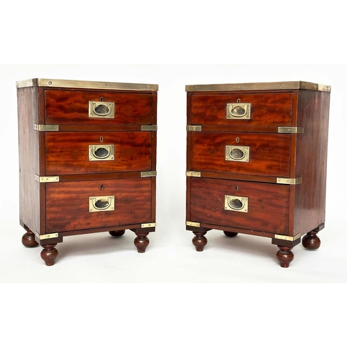 539 - CAMPAIGN CHESTS, a pair, mahogany and brass bound each with three drawers and turned supports, 44cm ... 