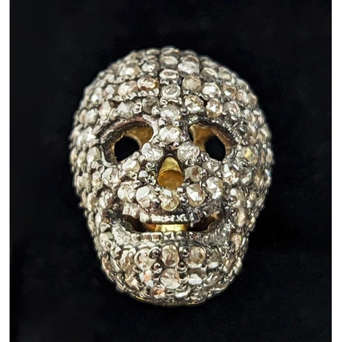 57 - A PAIR OF SILVER-GILT MEMENTO MORI-STYLE SKULL CUFFLINKS, with pave set rose cut diamonds, approxima... 