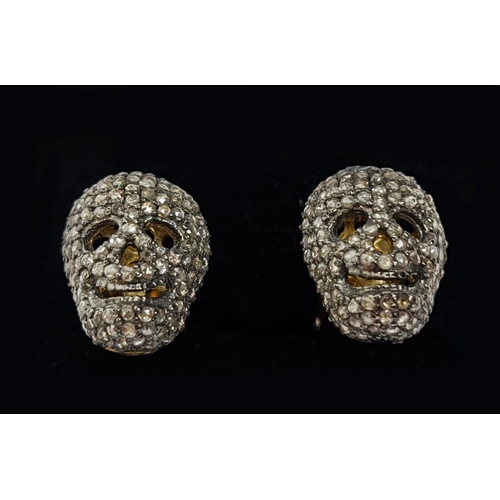 57 - A PAIR OF SILVER-GILT MEMENTO MORI-STYLE SKULL CUFFLINKS, with pave set rose cut diamonds, approxima... 