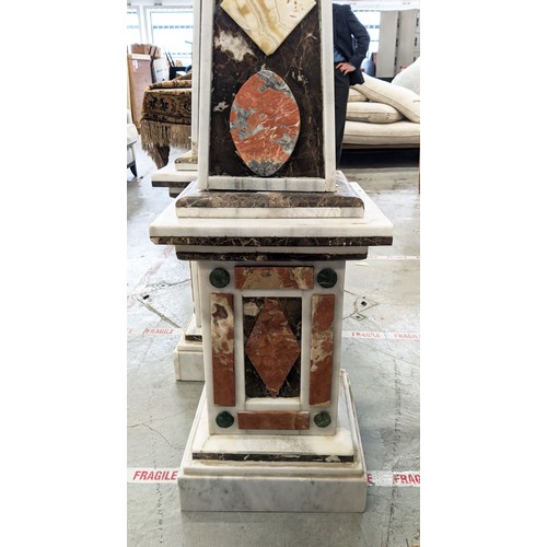 335 - MARBLE OBELISKS, a pair, large scale with various  stone applied decoration 182cm H x 40cm W. (2)