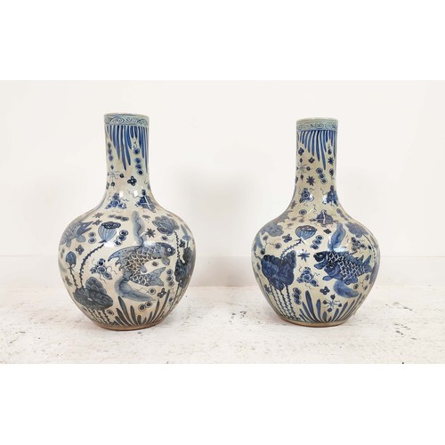 336 - BOTTLE VASES, a pair, Chinese style blue and white ceramic, 60cm H x 38cm W. (2)