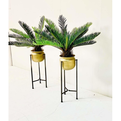 359 - FAUX FERN TREES, in gilt metal planters, 115cm x 75cm x 75cm.