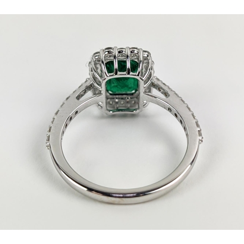 36 - AN 18CT WHITE GOLD EMERALD AND DIAMOND SET DRESS RING, the central step-cut emerald of approximately... 