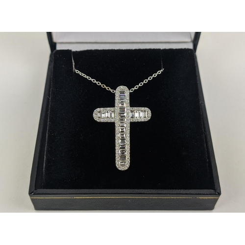 37 - A 18CT WHITE GOLD DIAMOND SET CROSS PENDANT, set with baguette cut diamonds and a border of round br... 