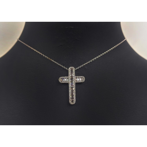 37 - A 18CT WHITE GOLD DIAMOND SET CROSS PENDANT, set with baguette cut diamonds and a border of round br... 