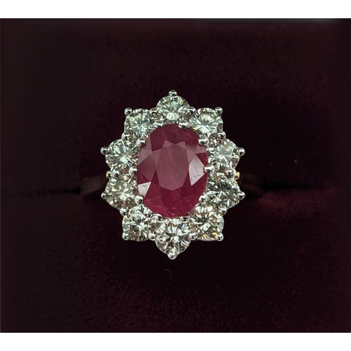 40 - AN 18CT GOLD RUBY AND DIAMOND CLUSTER RING, the central mixed cut ruby of approximately 2.25 carats,... 