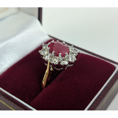 40 - AN 18CT GOLD RUBY AND DIAMOND CLUSTER RING, the central mixed cut ruby of approximately 2.25 carats,... 