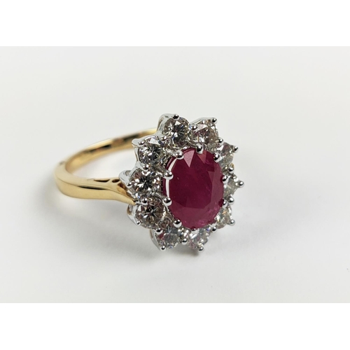 40 - AN 18CT GOLD RUBY AND DIAMOND CLUSTER RING, the central mixed cut ruby of approximately 2.25 carats,... 